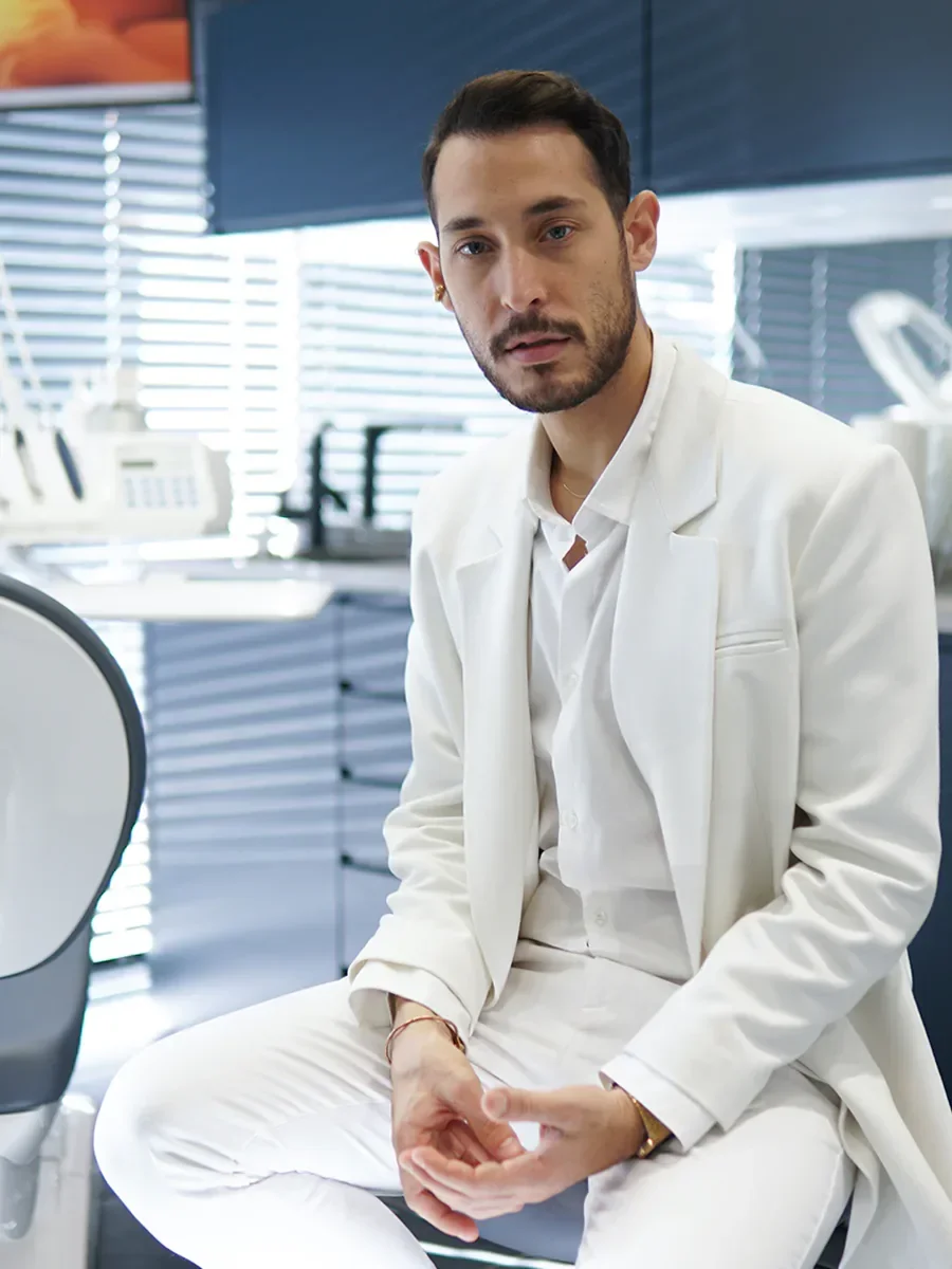 Dt. Doğa Erginoğlu sitting by the window in the treatment room