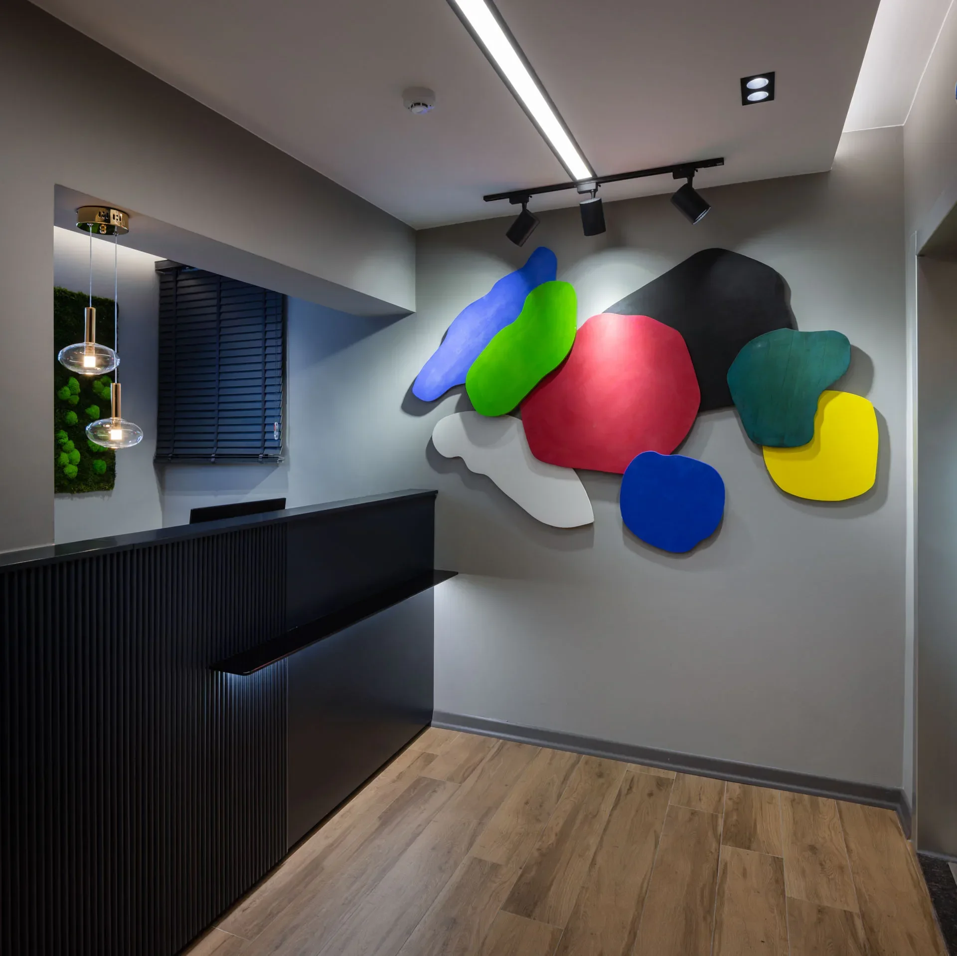 Reception desk and colourful wall piece